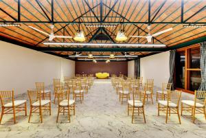 a large room with chairs and tables and a stage at Indo Asia Heritage Coorg, formerly Heritage Resort Coorg in Madikeri +74 photos