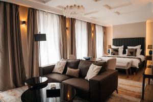 a living room with a couch and a bed at Castle Hill Residence in Karlovy Vary