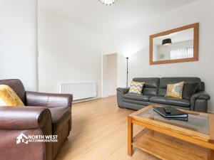 a living room with two couches and a coffee table at Leigh 2-Bedroom House Near Haydock & Wigan in Leigh