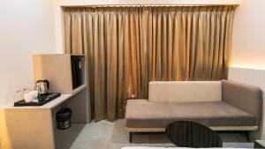 a living room with a chair and a television at Hotel Pinaki Inn in Ujjain +47 photos