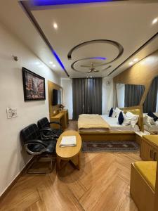 a hotel room with a bed and a table at HOTEL ELiTE in Pānīpat