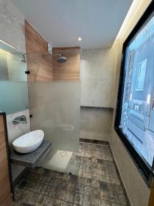 a bathroom with a glass shower with a toilet at HOTEL ELiTE in Pānīpat +42 photos