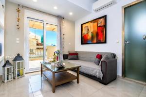 a living room with a couch and a table at Victor Junior Suite by "elite" in Zakynthos