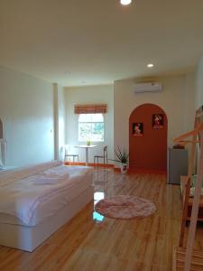 a bedroom with a bed and a staircase in it at โรงแรม JP Lucky Lux Hotel in Ban Nong Samran