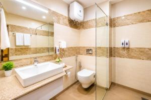 a bathroom with a sink and a toilet at Hotel Ram krishna Residency in Brahmapur