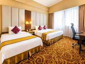 a hotel room with two beds and a desk at Hotel Ram krishna Residency in Brahmapur