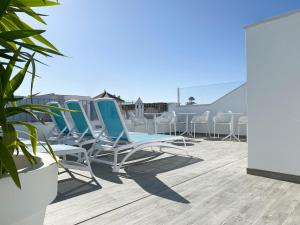 a group of chairs sitting on a roof at Nerja Casual Rooms in Nerja