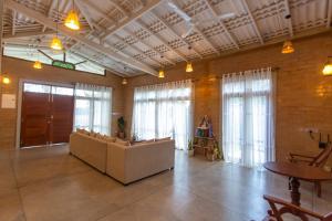 a lobby with a couch and some windows at Legato House in Talpe