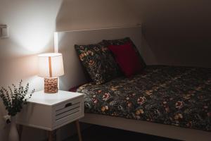 a bedroom with a bed and a night stand with a lamp at Pargi apartment 2 in Viljandi