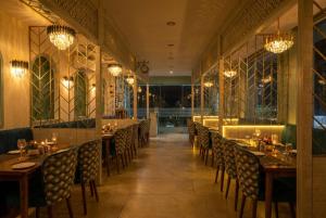 a row of tables and chairs in a restaurant at Hotel Andies in Mohali