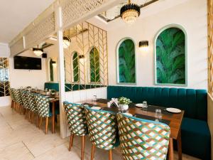 a row of tables and chairs in a restaurant at Hotel Andies in Mohali