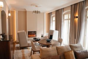 a living room with a couch and a table at Castle Hill Residence in Karlovy Vary