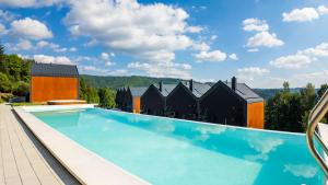 a swimming pool on the roof of a building at Wisła View, Sun&Snow in Wisła