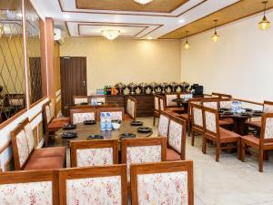 a dining room with wooden tables and chairs at Hotel Andies in Mohali
