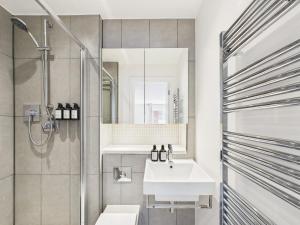 a bathroom with a sink and a shower at Westminster Residences by Apt in London +98 photos