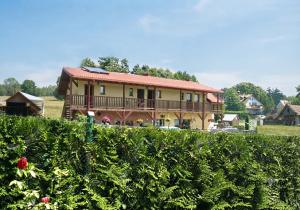 a large house with a balcony in a field at Gościniec Zośka in Ostrzyce