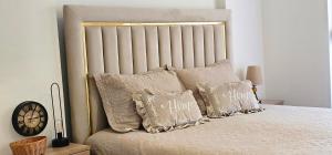 a bedroom with a bed with pillows on it at Value Living Apartment in Ferizaj