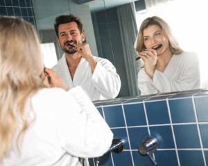 a man and woman brushing their teeth in the bathroom at Maison Arya in Brussels +21 photos