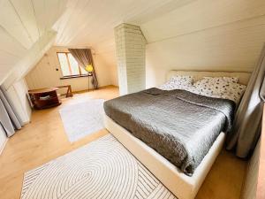 a bedroom with a large bed in a attic at Mäeotsa Country House in Laulasmaa