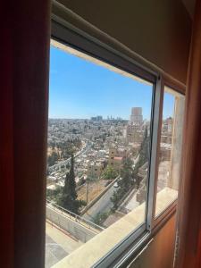a view of a city from a window at Zaina Plaza Hotel in Amman