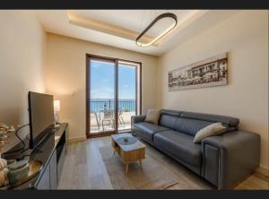 a living room with a couch and a television at Mar de Lux in Petrovac na Moru