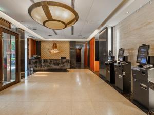 a lobby of a building with a large ceiling at Guide Hotel Taipei Chongqing in Taipei