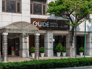 a building with a college hotel sign on it at Guide Hotel Taipei Chongqing in Taipei