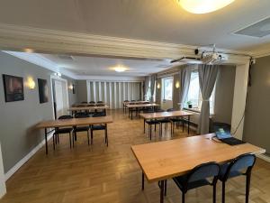 a large room with tables and chairs and a laptop at Lokatten Wärdshus in Los