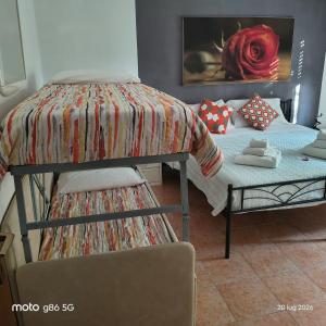 a bedroom with two bunk beds and a bed with a cushion at Residenza Le Rose Apartament FREE BIKE in Peschiera del Garda
