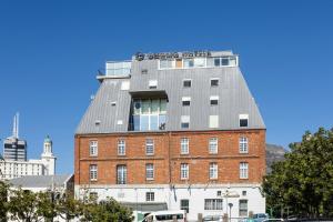 a building with a gray roof on top of it at ONOMO Hotel Waterfront in Cape Town