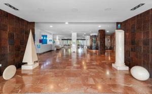 a large room with a lobby with marble floors and columns at BLUESEA Al Andalus in Torremolinos
