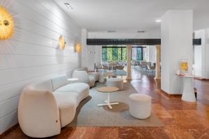 a living room with a couch and chairs and tables at BLUESEA Al Andalus in Torremolinos