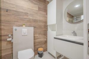 a bathroom with a toilet and a sink and a mirror at Mar de Lux in Petrovac na Moru +19 photos