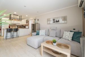 a living room with a couch and a table at Paz Ocean View Luxury, 2 Air conditioners, Fast Wifi, Heated pool in San Miguel de Abona