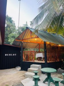 a tent with a table and chairs in front of it at Merlot in Deniyaya +1 photo