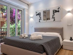 a bedroom with a bed with two towels on it at ABBA ROOMS in Cagliari +23 photos