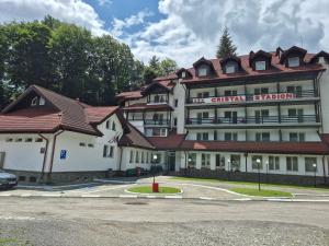 a large building with a red roof at Cristal Sinaia in Sinaia