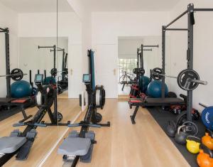 a gym with several treadmills and exercise bikes at Villa Rafa in Costa Nova
