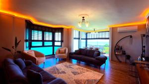a living room with a couch and chairs in a room at cam teras villa in Cayeli