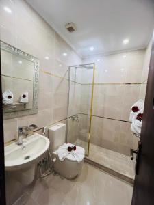 a bathroom with a toilet and a sink and a shower at Town Hotel Cairo in Cairo