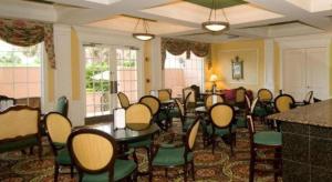 a room with a bunch of chairs and tables at The Capri Inn in Naples +55 photos