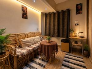 a living room with a couch and a table at Grand Duplex in Aswan