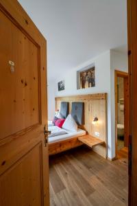 a bedroom with a bed with a wooden floor at Untersillerhof in Neustift im Stubaital