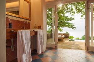 a kitchen with a large sliding glass door leading to a patio at Belo Monte - Principe Collection in Santo António +19 photos