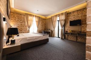 a bedroom with a large bed and a brick wall at Air Solief in Tashkent +39 photos