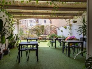 an outdoor patio with tables and chairs and plants at CeO LUXURY SUITE DI CAGLIARI in Cagliari