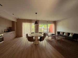 a kitchen and a living room with a table and chairs at Geirangerbooking in Geiranger