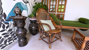 a living room with a chair and a couch at Aryavilla Heritage in Varkala