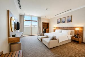 a large bedroom with a large bed and a television at فندق تيلا TeeLA HoTeL in Medina