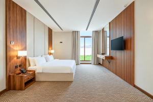 a hotel room with a bed and a television at فندق تيلا TeeLA HoTeL in Medina